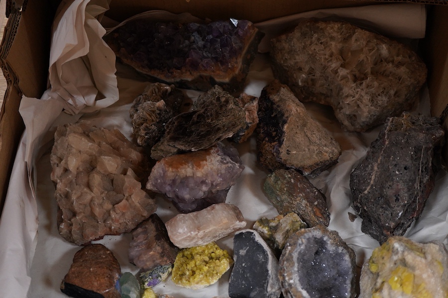 A collection of mineral and crystal samples, including large quartz segments and a good variety of other crystal formations